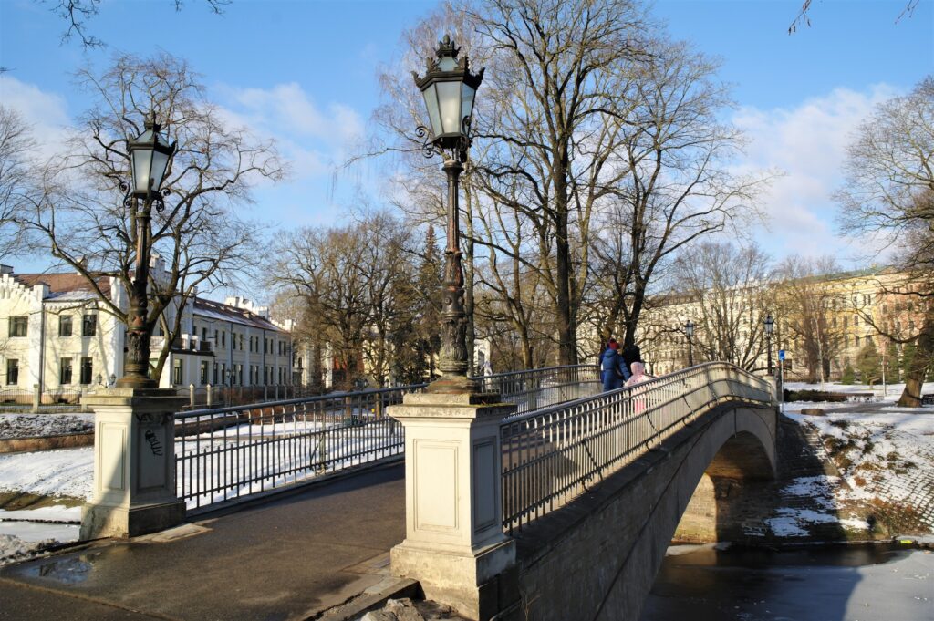 A woman and a child crossing a bridge in the Bastejkalns park in Riga.