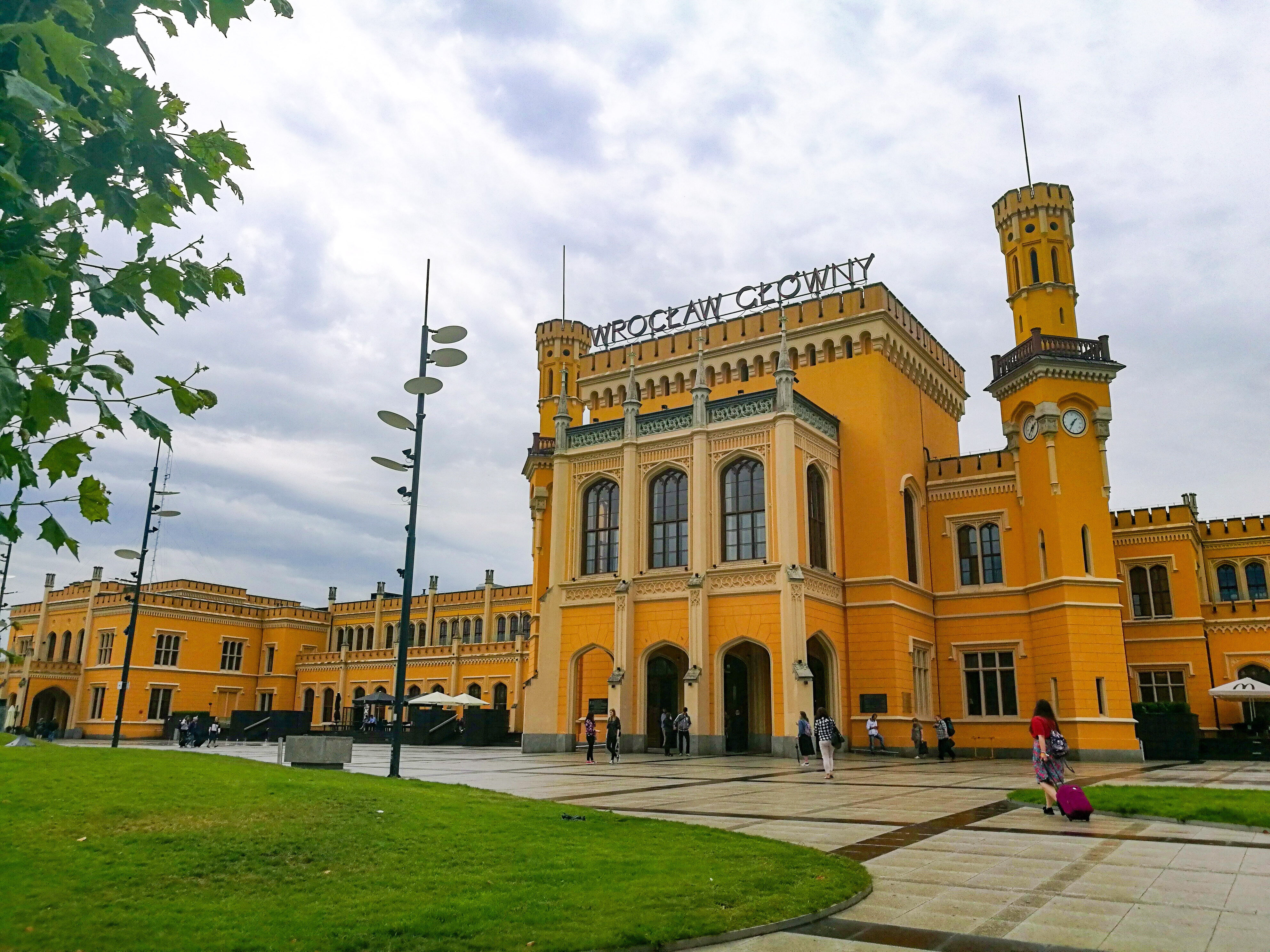 The bright yellow Wroclaw train station on a gloomy day