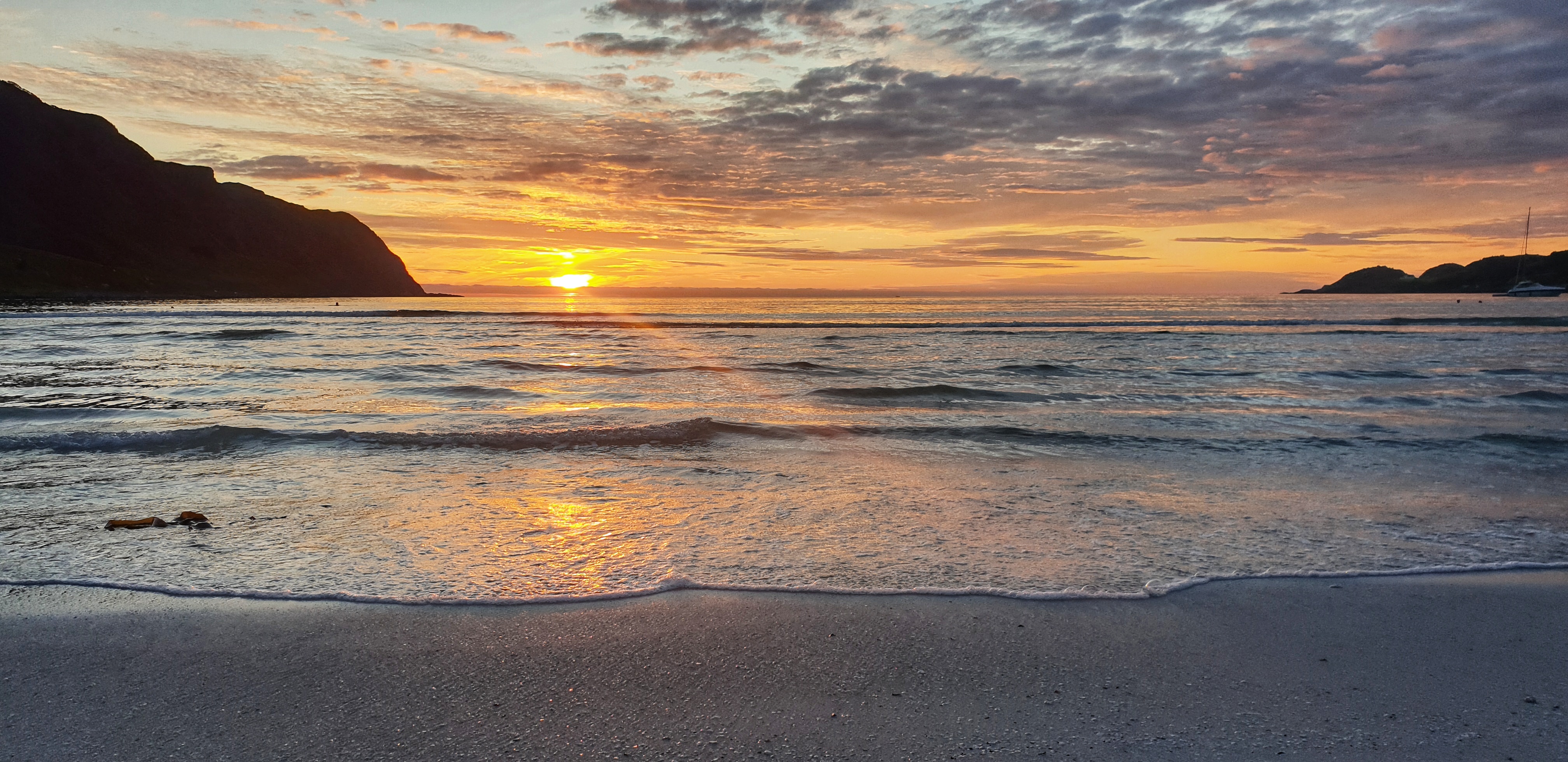Sun setting in the horizon seen from Refviksanden beach