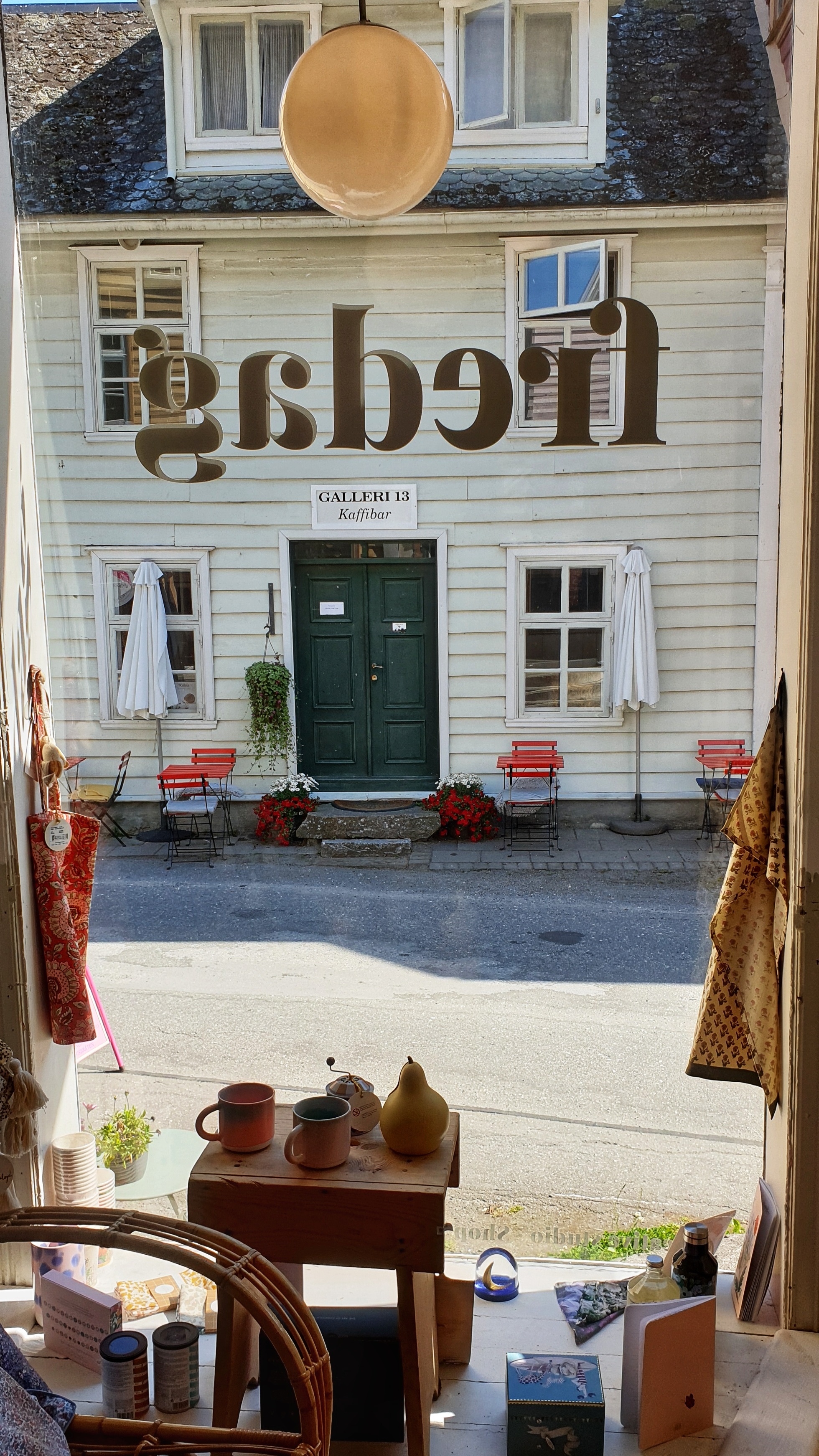 Street view from the window at Fredag in LÆrdal, with items for sale in front