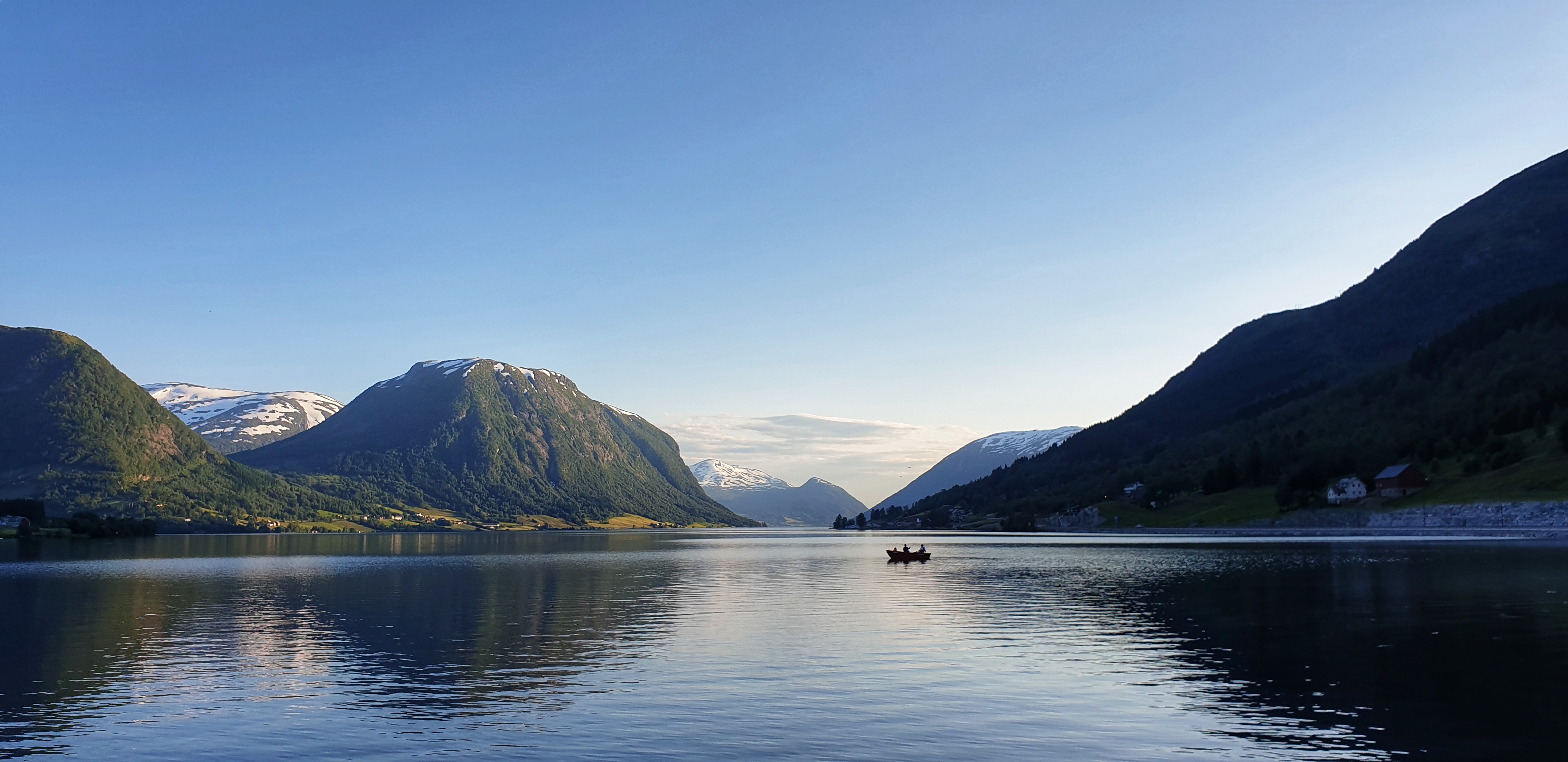 A boat on JØlstravatnet lake in Skei on a bright summer evening.