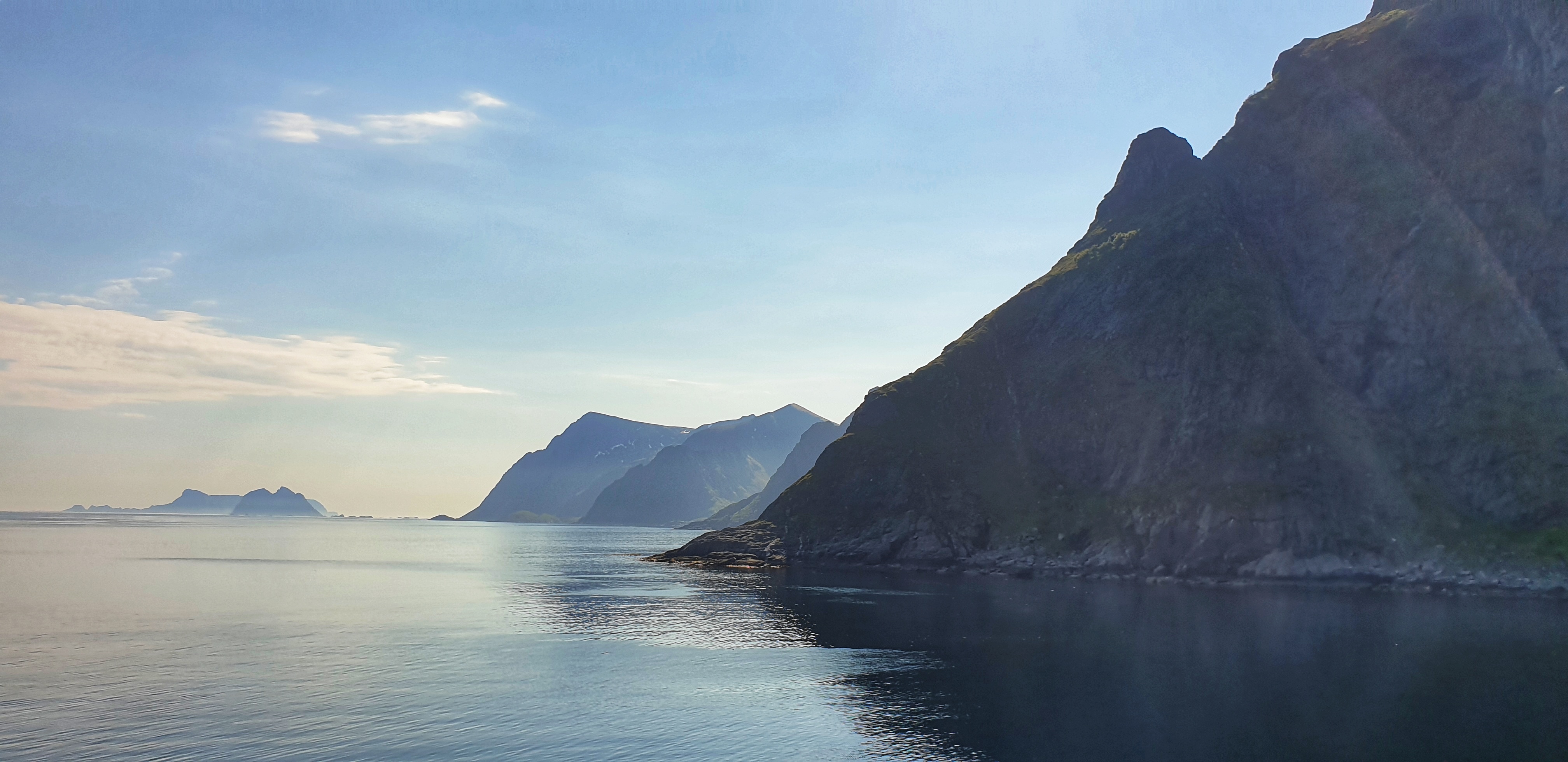 Mountains lining the sea seen from Ã… in Lofoten. Islands in the distance.