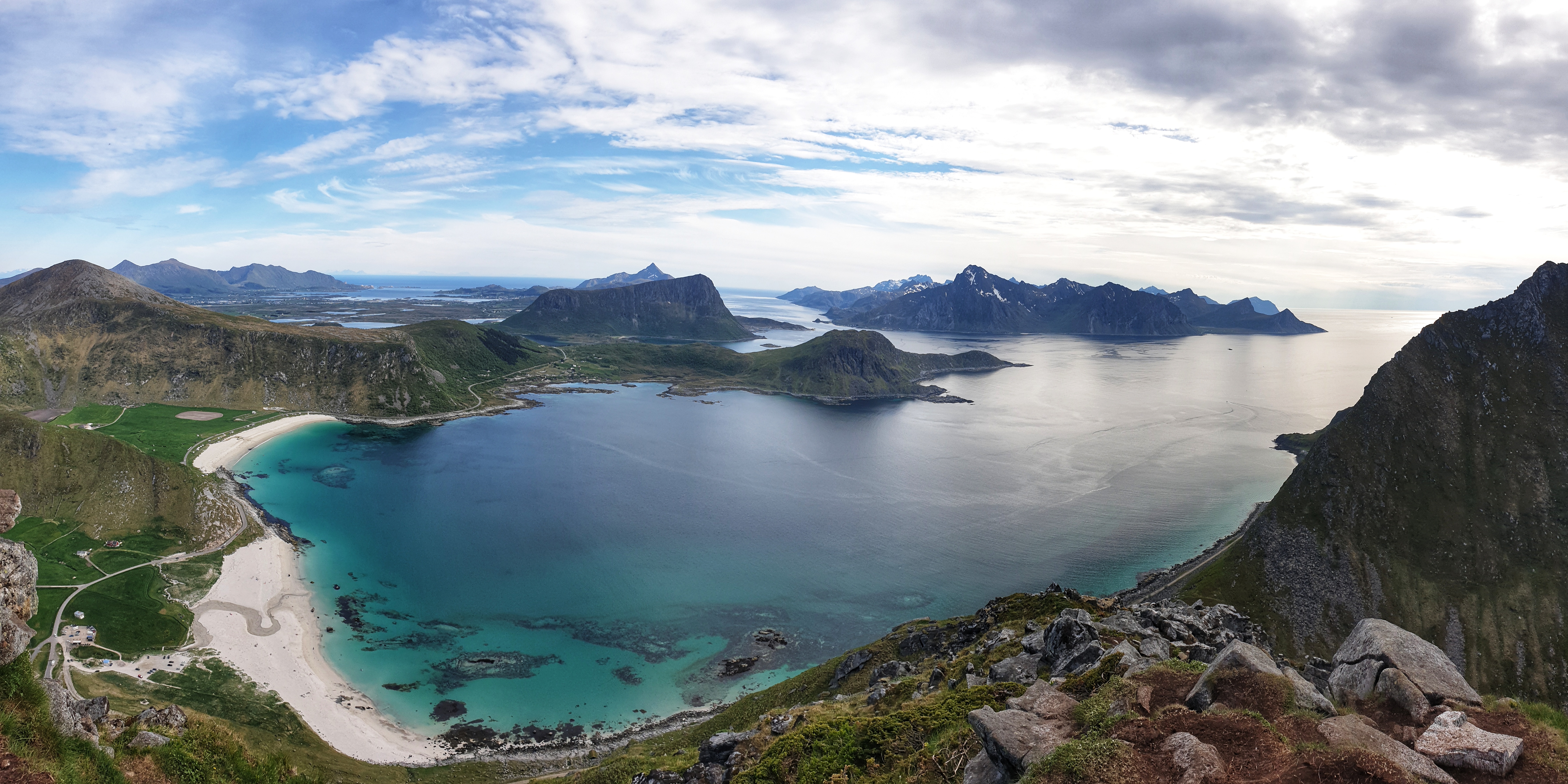 View of Hauklandstranda and Vik beaches, mountain ranges, sea and islands from mt. Mannen in Lofoten.