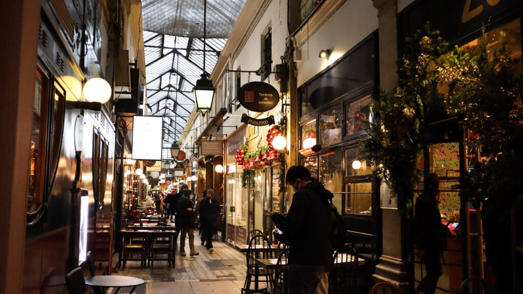 People inside a festive decorated Passage des Panoramas.
