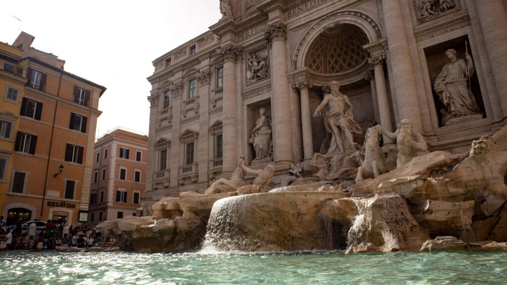 The Trevi fountain in Rome, with turquoise water in front.