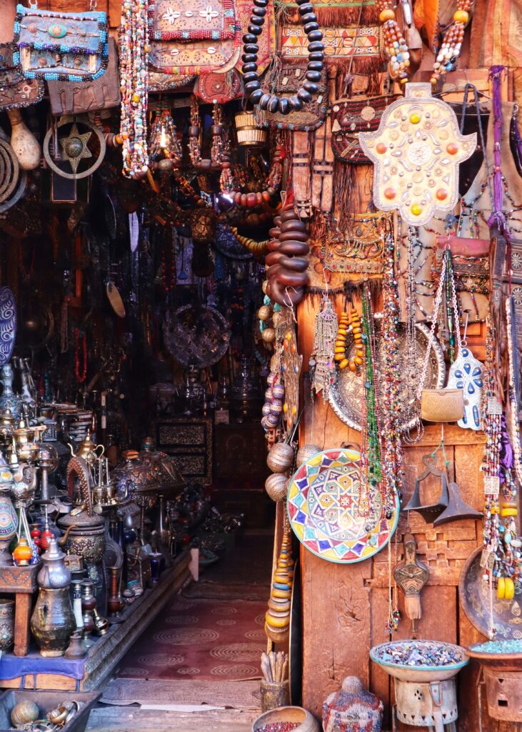 Entrance to an antique shop in Marrakech Medina. Jewlery, painted plates, tin work, tea pots, and much more hanging and standing around.