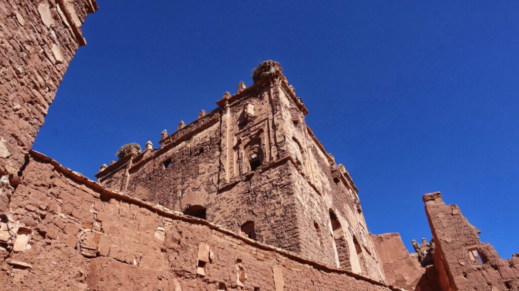 Exterior of Kasbah Telouet against blue sky.