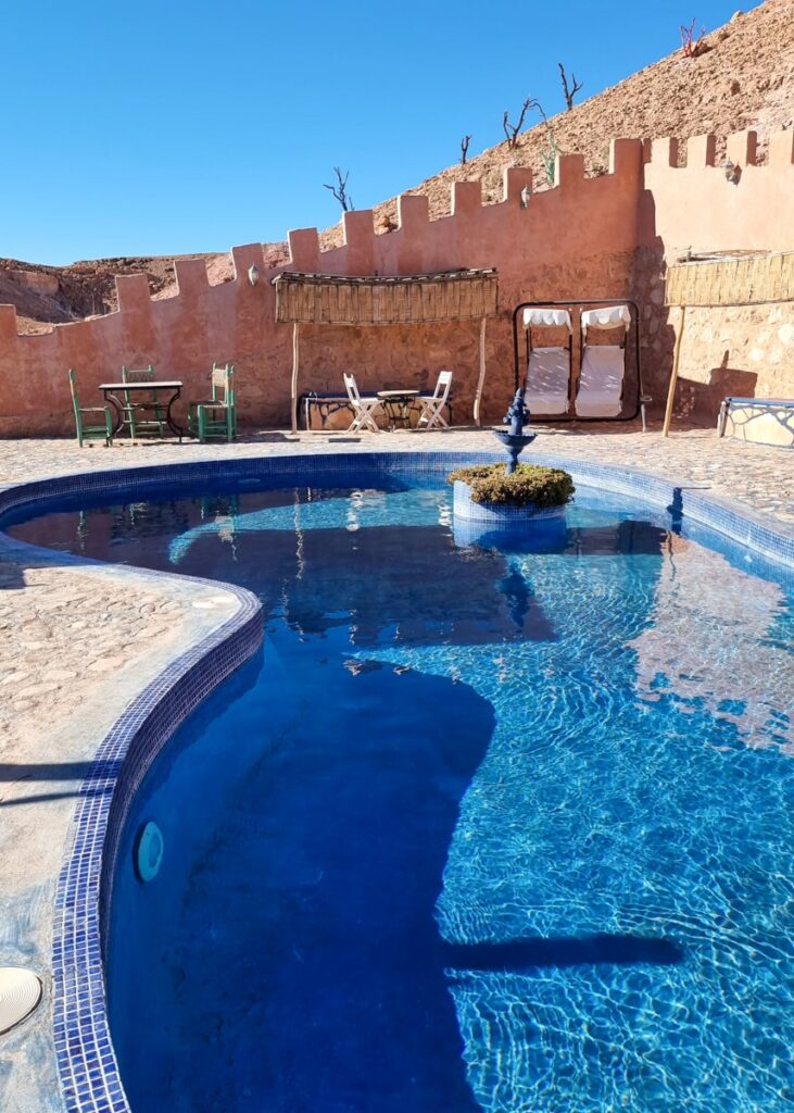Riad Paradise of Silence pretty pool. Lounge chairs and tables and chairs on the side.