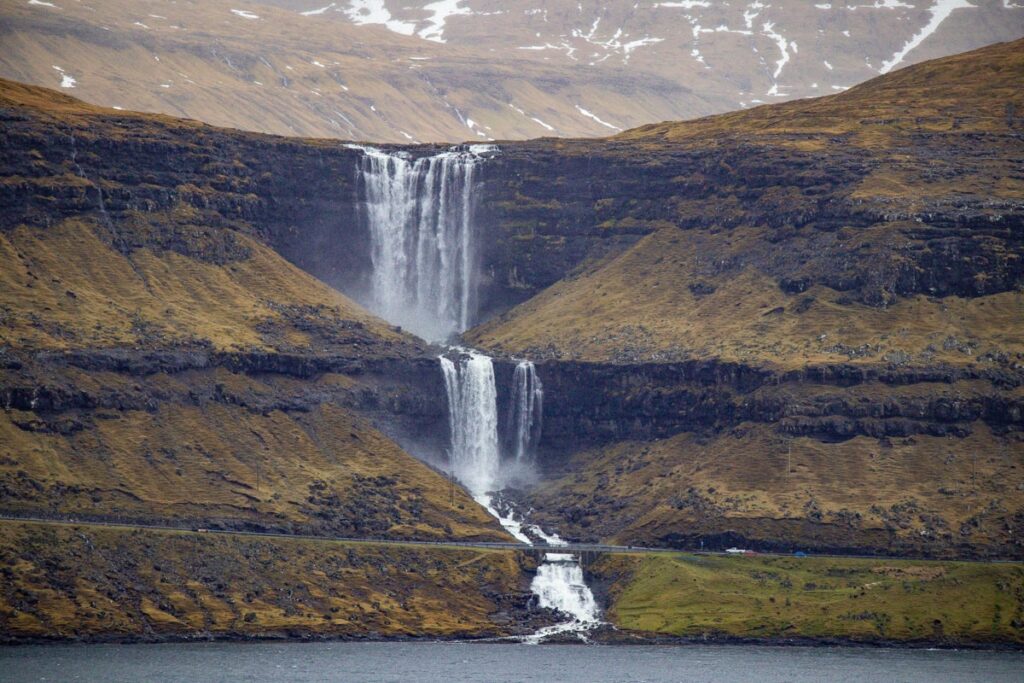 Fossá waterfall in the Faroe Islands seen from across the fjord.