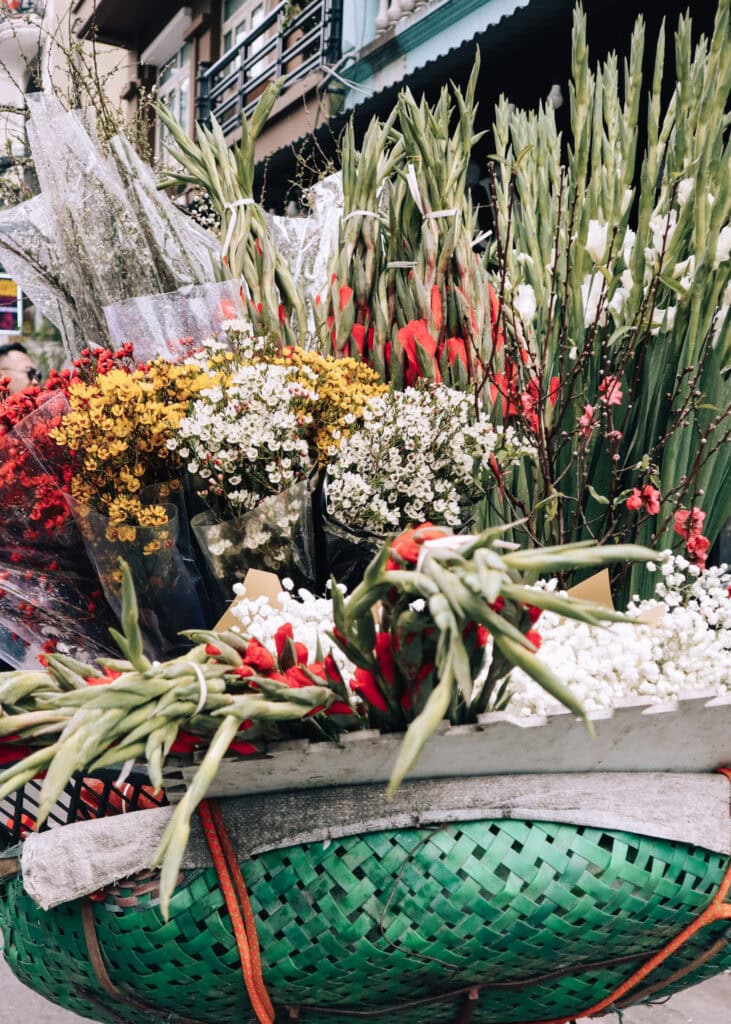 Close-up of a bicycle full of flowers.