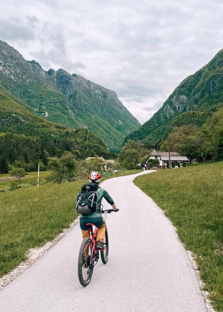 A woman bicycling on rural roads in Bovec.
