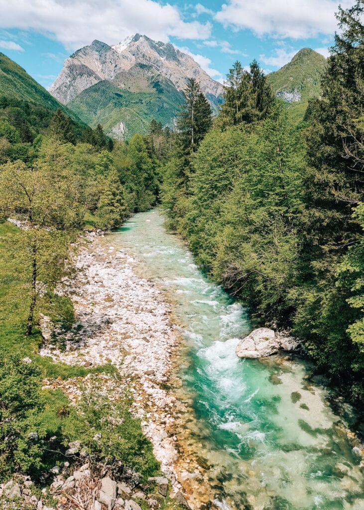 Photo of green and mountainous valley near Soca in Bovec. Turquoise river.