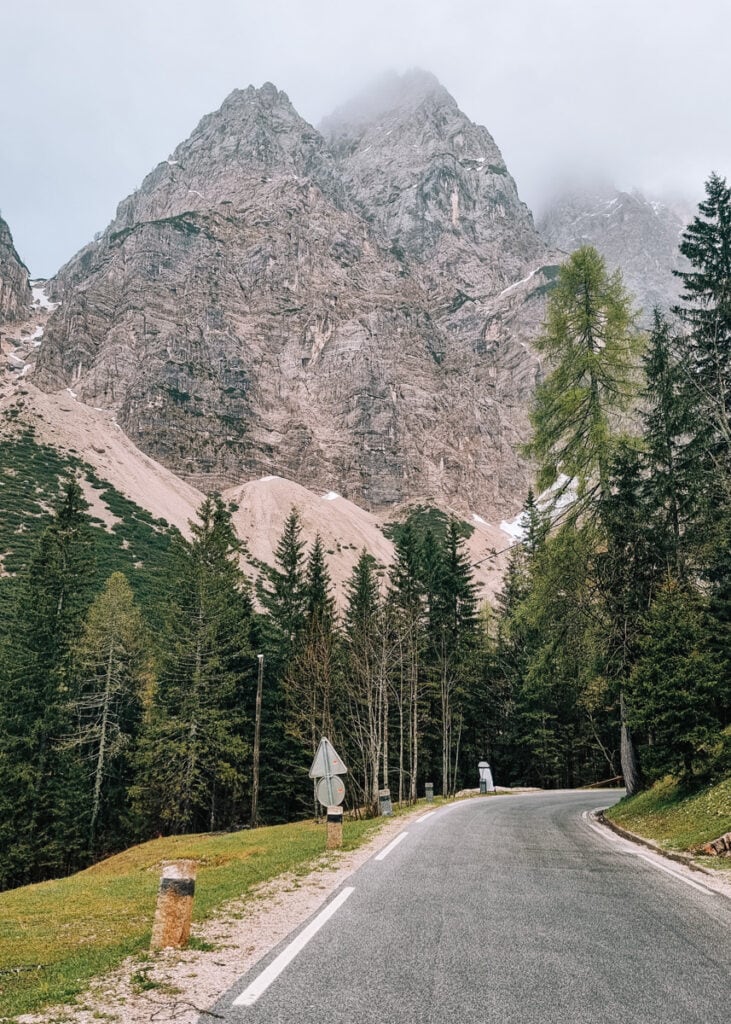View of rugged mountains and forest from a road in Triglav National Park.