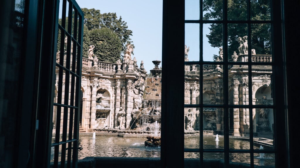 The Nymphenbad at the Zwinger Palace seen through glass doors.