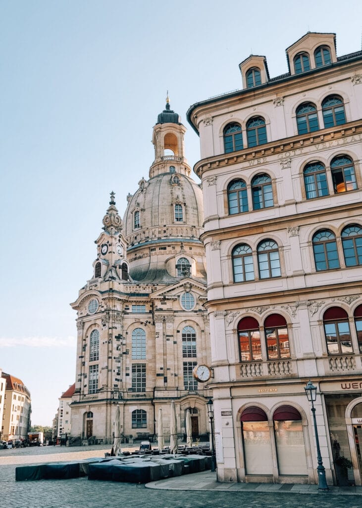 The Church of Our Lady seen behind another majestic building on Dresden's Neumarkt.