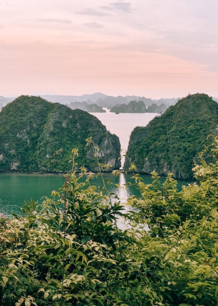 View of many layers of limestone karsts under a pink sky seen from Ti Top Island.