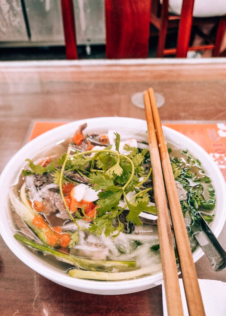 A bowl of pho garnished with coriander at Pho 10 in Hanoi.