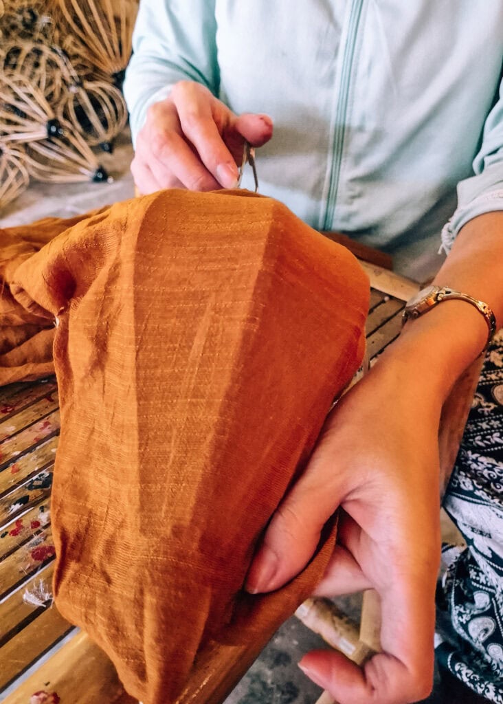 A teacher at a lantern workshop demonstrating how to stretch the fabric.