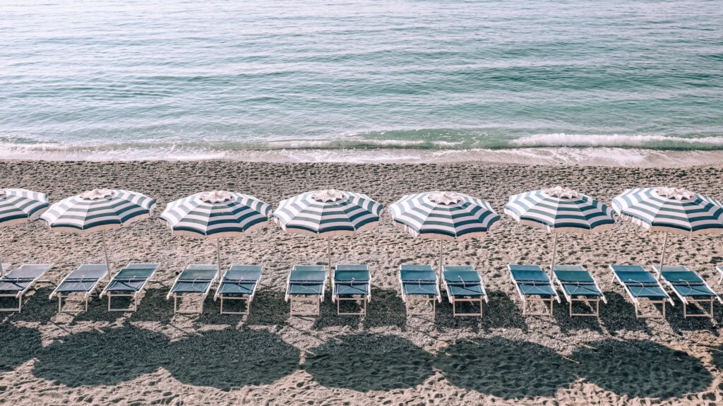 Sunbeds and umbrellas on an empty beach in Monterosso al Mare.