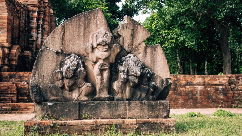 A partly broken stone showing old hindu symbols.