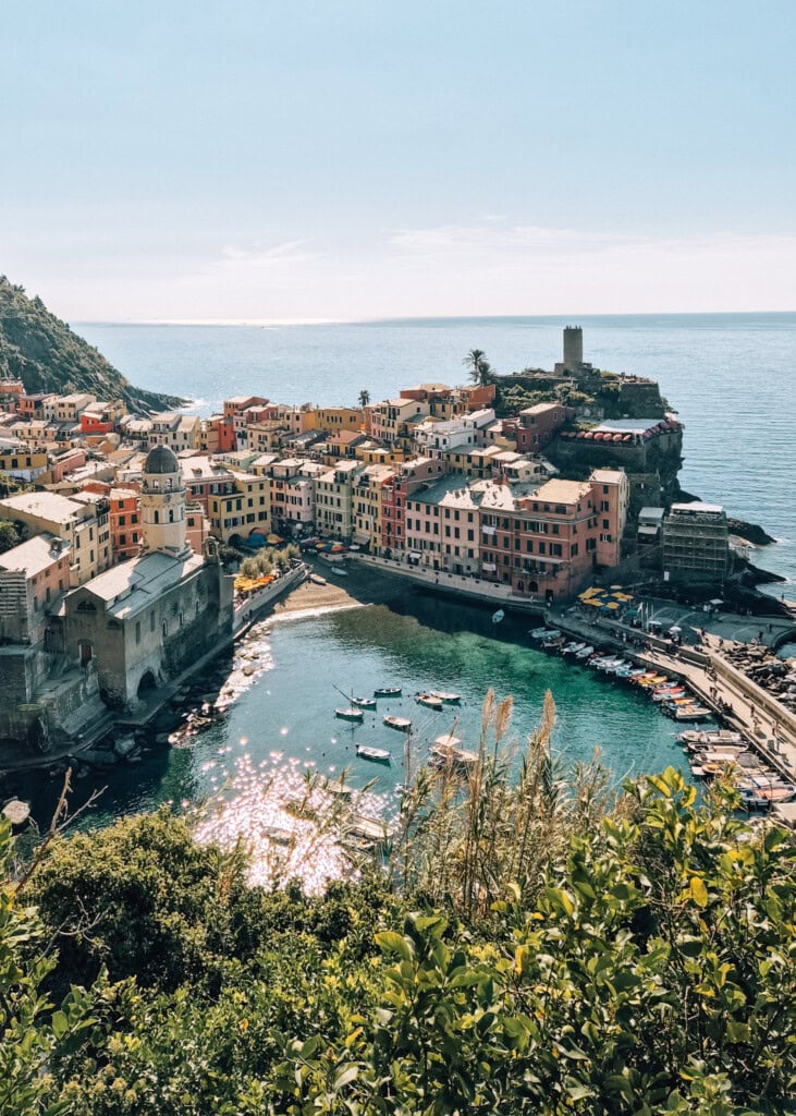 View down to Vernazza from the hiking trail. Colourful buildings, azure sea and small fishing boats.