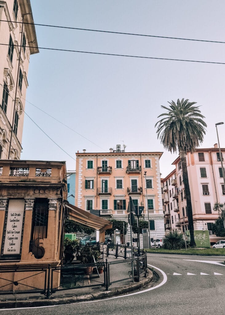 Street photo from La Spezia. Colourful houses, a bar and a street.