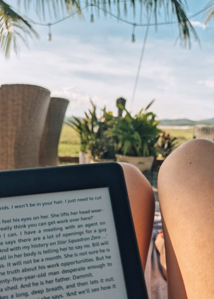 Picture of a kindle resting on two legs on a sunbed at Phong Nha Farmstay.
