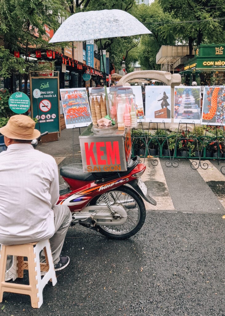 A man selling ice cream from his motorbike in front of Ho Chi Minh City Book Street.