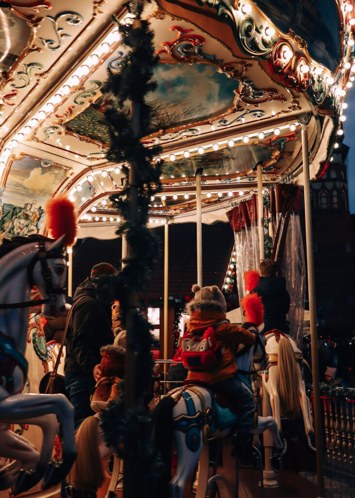 A traditional carousel with horses and beautifful, historic painting at Gdansk Christmas Market.