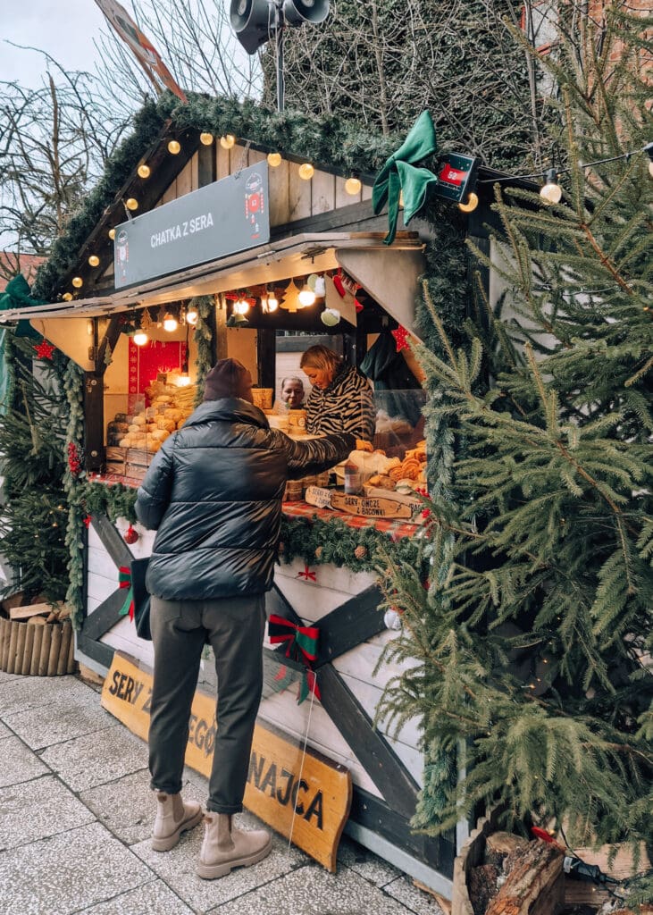 A woman buying cheese from a stall in Gdansk.
